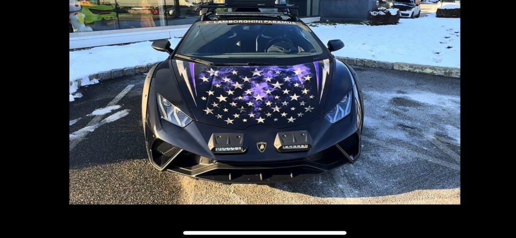 The Outrun Opioids Lamborghini Huracán Sterrato parked outdoors on a winter day, roof light bar fitted and snow on the ground behind it