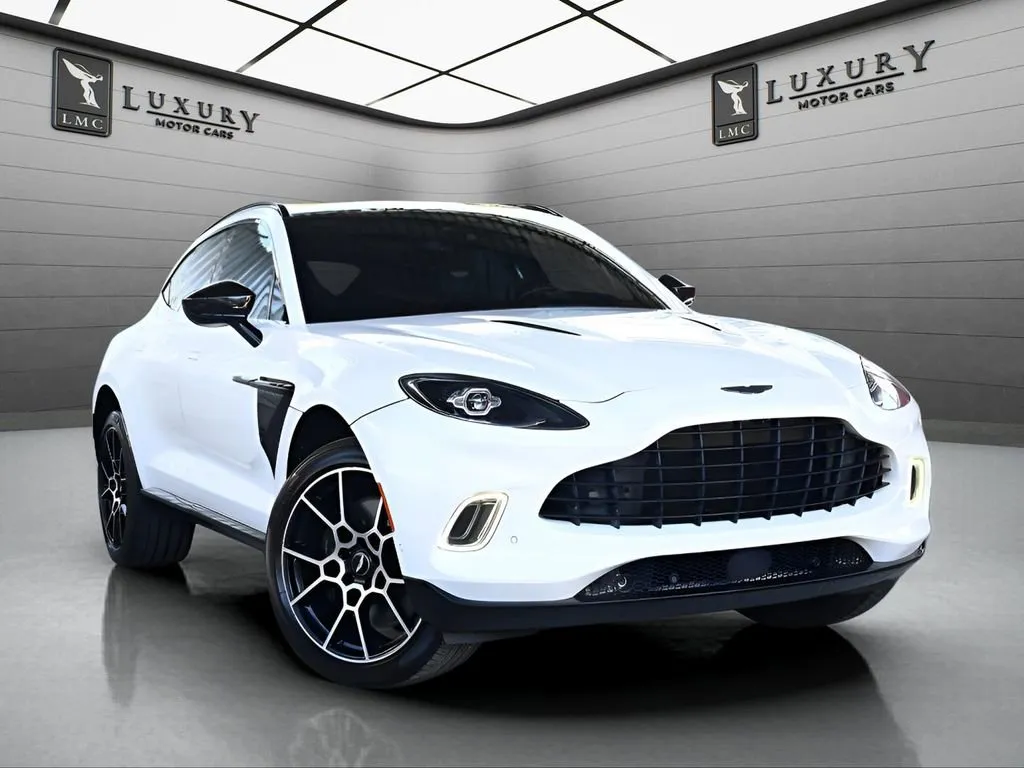 White Aston Martin DBX luxury performance SUV showcased at Luxury Motor Cars, ExoticMotors.com Dealer of the Month.