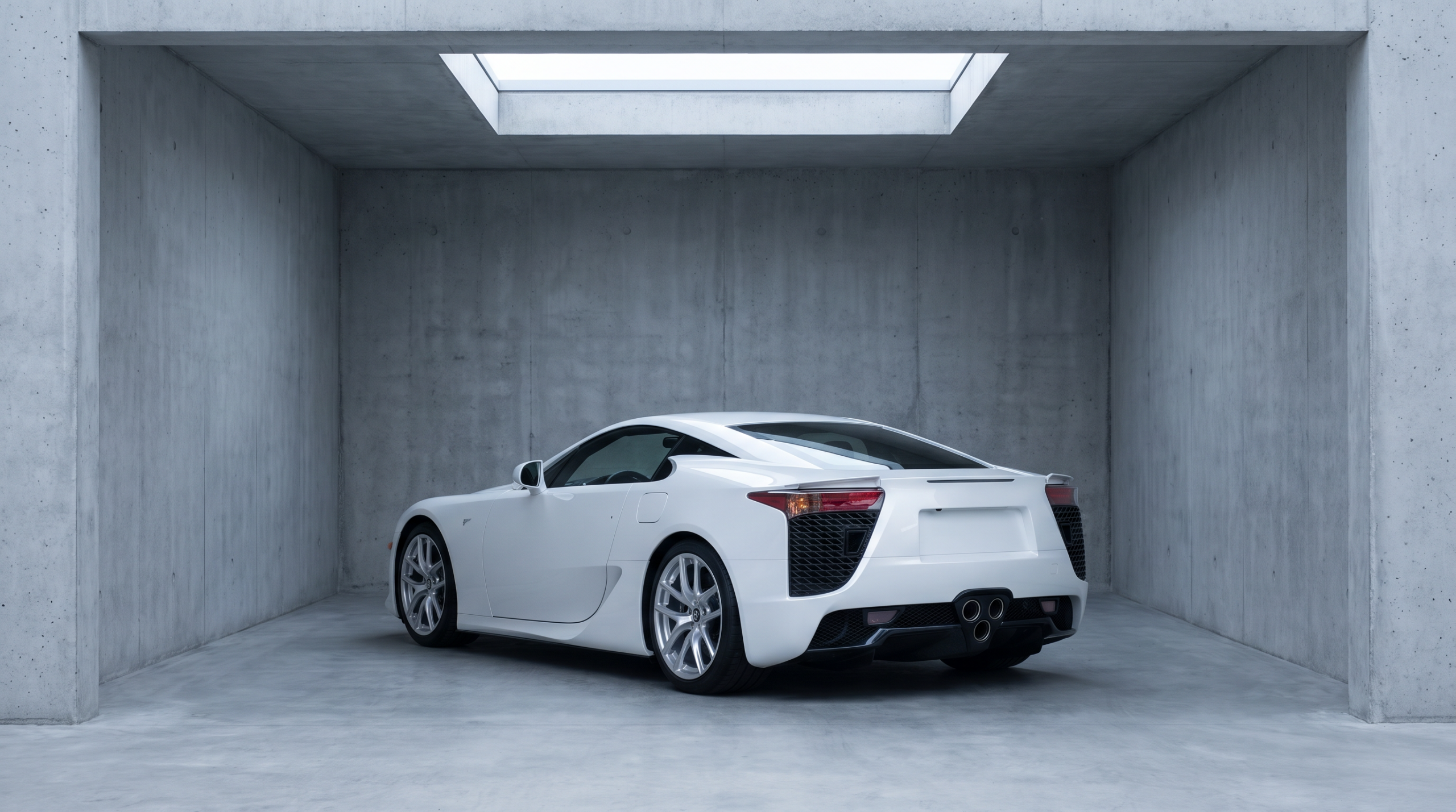 Exotic car values reassessed: a pearl white V10 coupe with triangular triple exhausts in a concrete gallery space