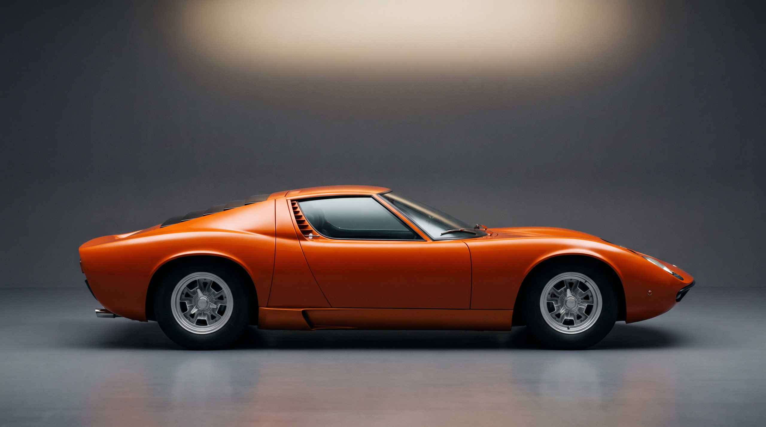 Low 1960s mid-engined Italian coupe in profile, the layout that defined exotic cars
