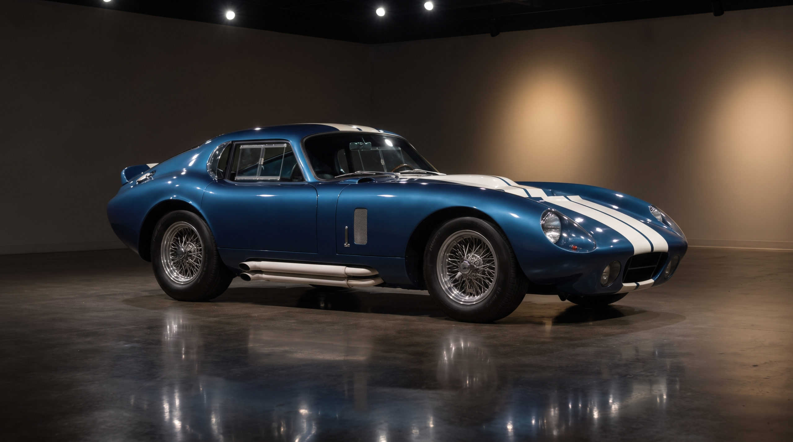 A 1960s American racing coupe displayed under gallery lighting