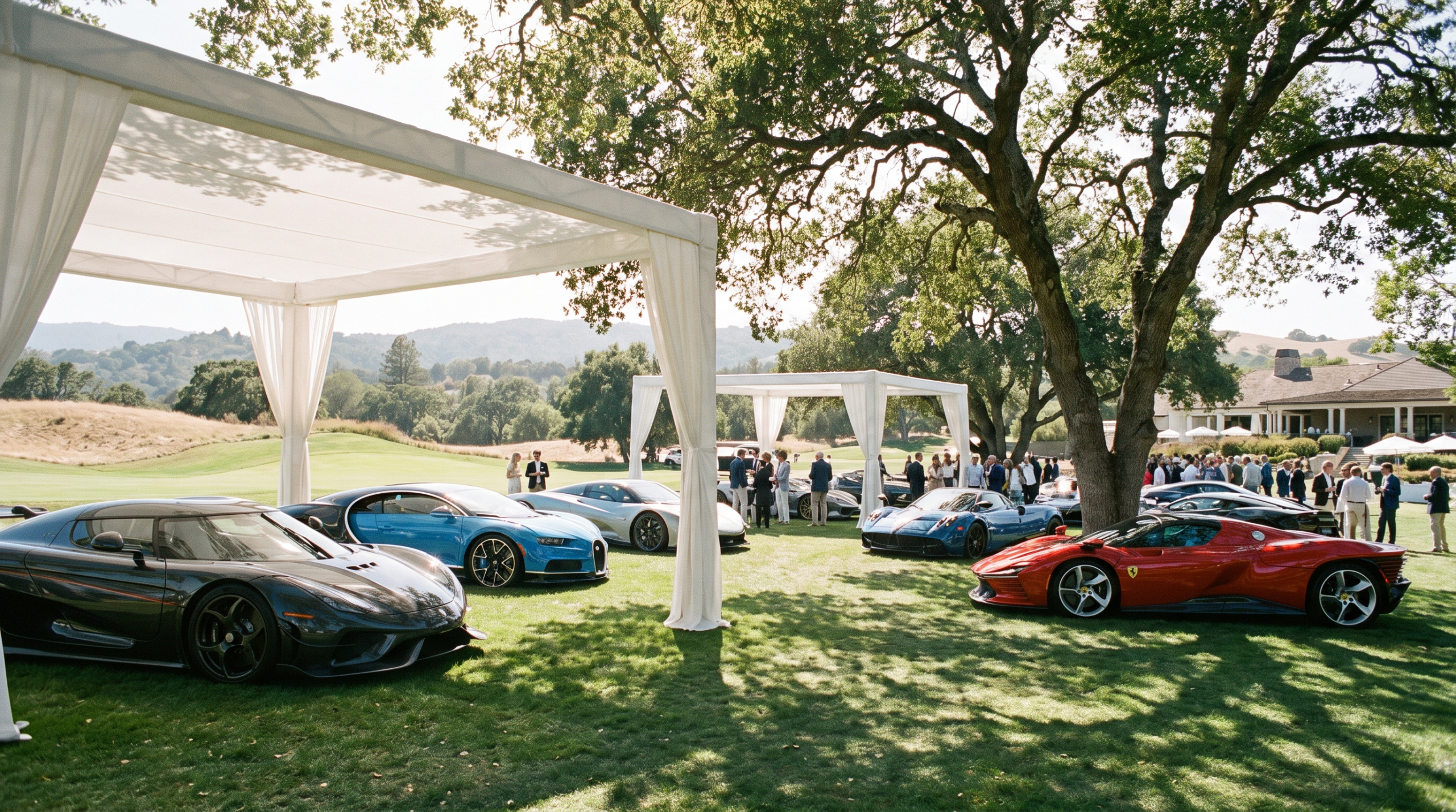 Modern supercars displayed under pavilions on a golf club lawn at Monterey Car Week