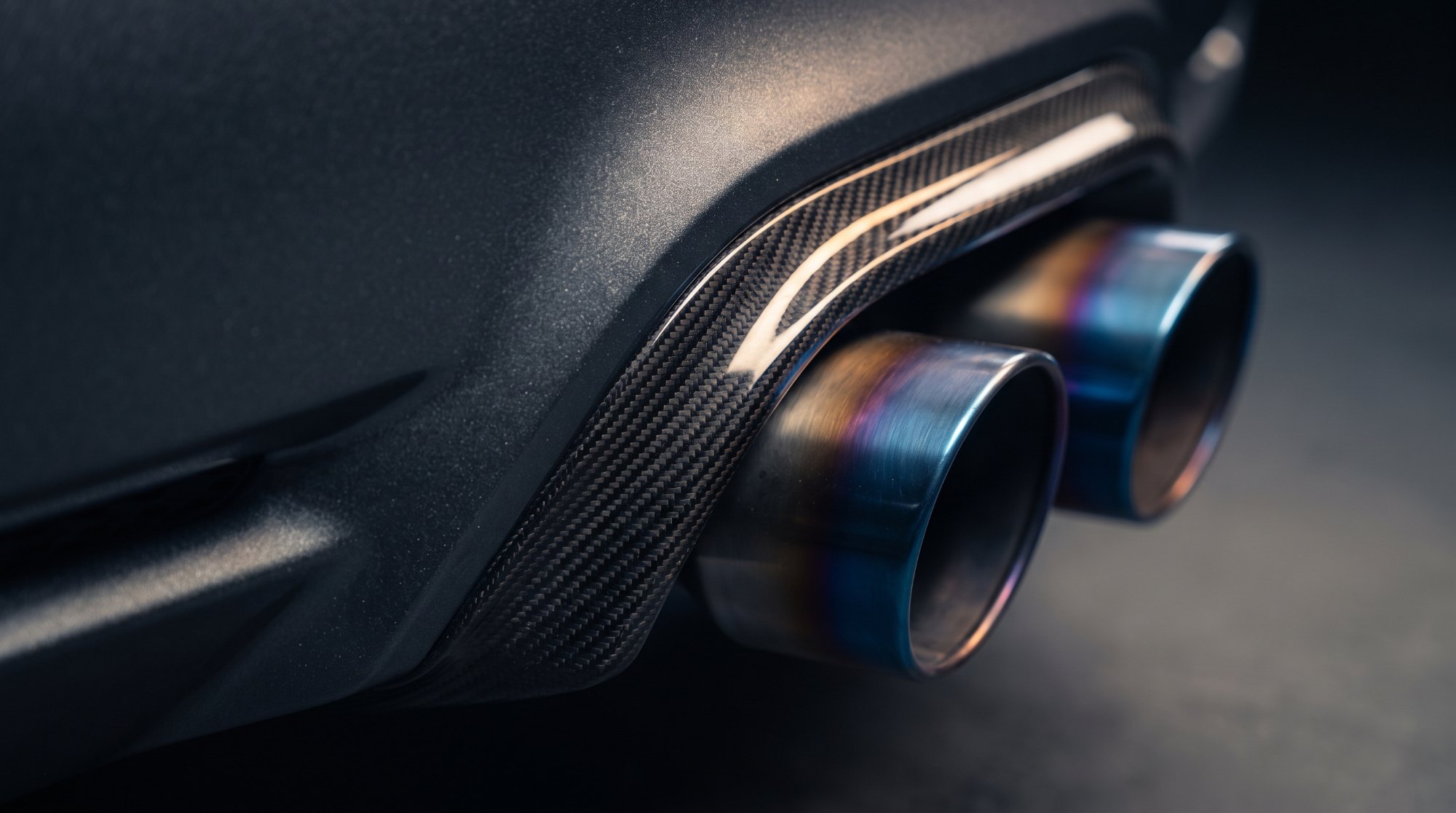 Carbon fibre rear diffuser and titanium exhaust tips on a modern supercar, illustrating the exotic car market 2026